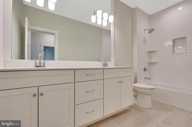 an empty room with wooden floor and ceiling fan