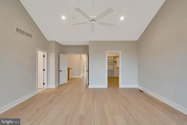 an empty room with windows and natural light