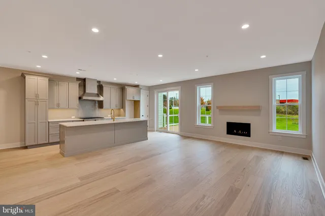 a large kitchen with a stove top oven a chimney and a fireplace