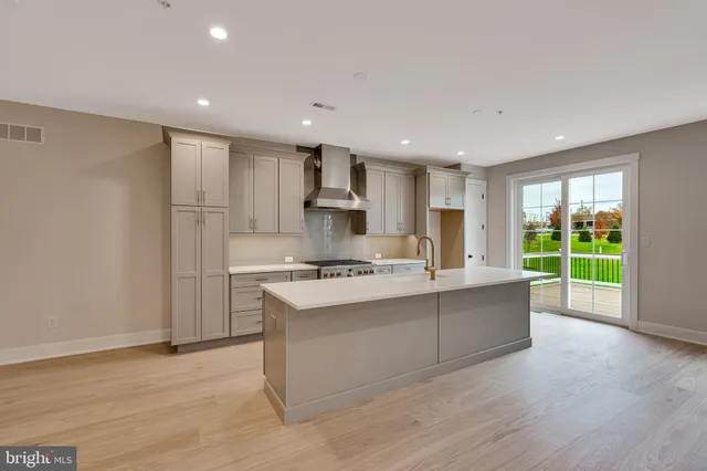 a view of kitchen with sink and refrigerator