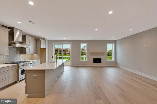 a large kitchen with granite countertop a large counter top stainless steel appliances and cabinets