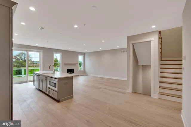 a view of empty room with a fireplace and wooden floor