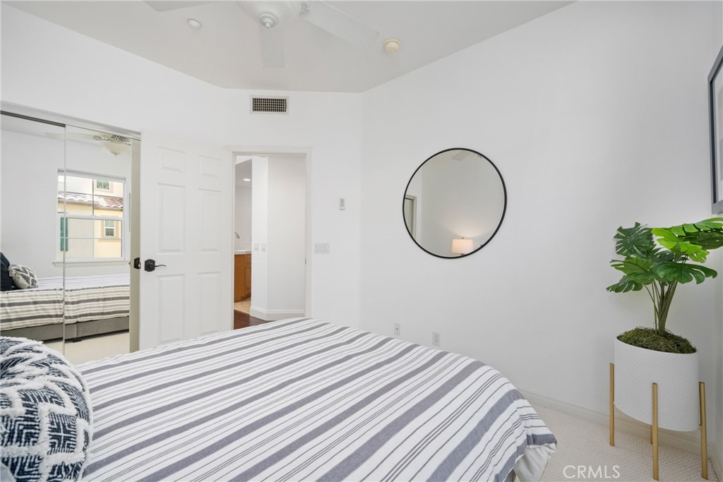 322 Dewdrop Irvine, CA 92603 - Photo 15 of 26 a bedroom with a bed and a potted plant