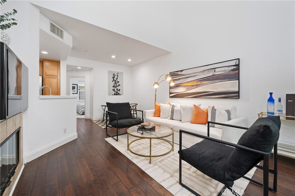 322 Dewdrop Irvine, CA 92603 - Photo 2 of 26 a living room with furniture a flat screen tv and kitchen view