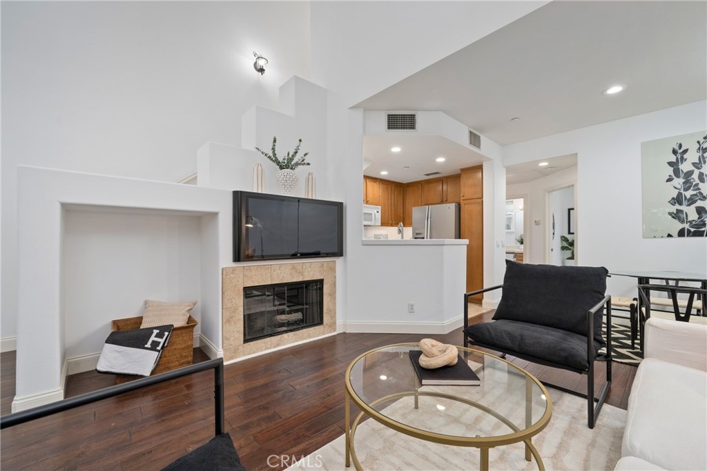 322 Dewdrop Irvine, CA 92603 - Photo 3 of 26 a living room with furniture a flat screen tv and a fireplace