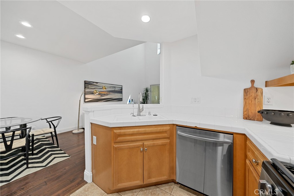 322 Dewdrop Irvine, CA 92603 - Photo 8 of 26 a kitchen with sink cabinets and wooden floor