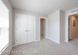 15481 Wildflower Circle Naples, FL 34119 - Photo 6 of 7 a view of an empty room with a window