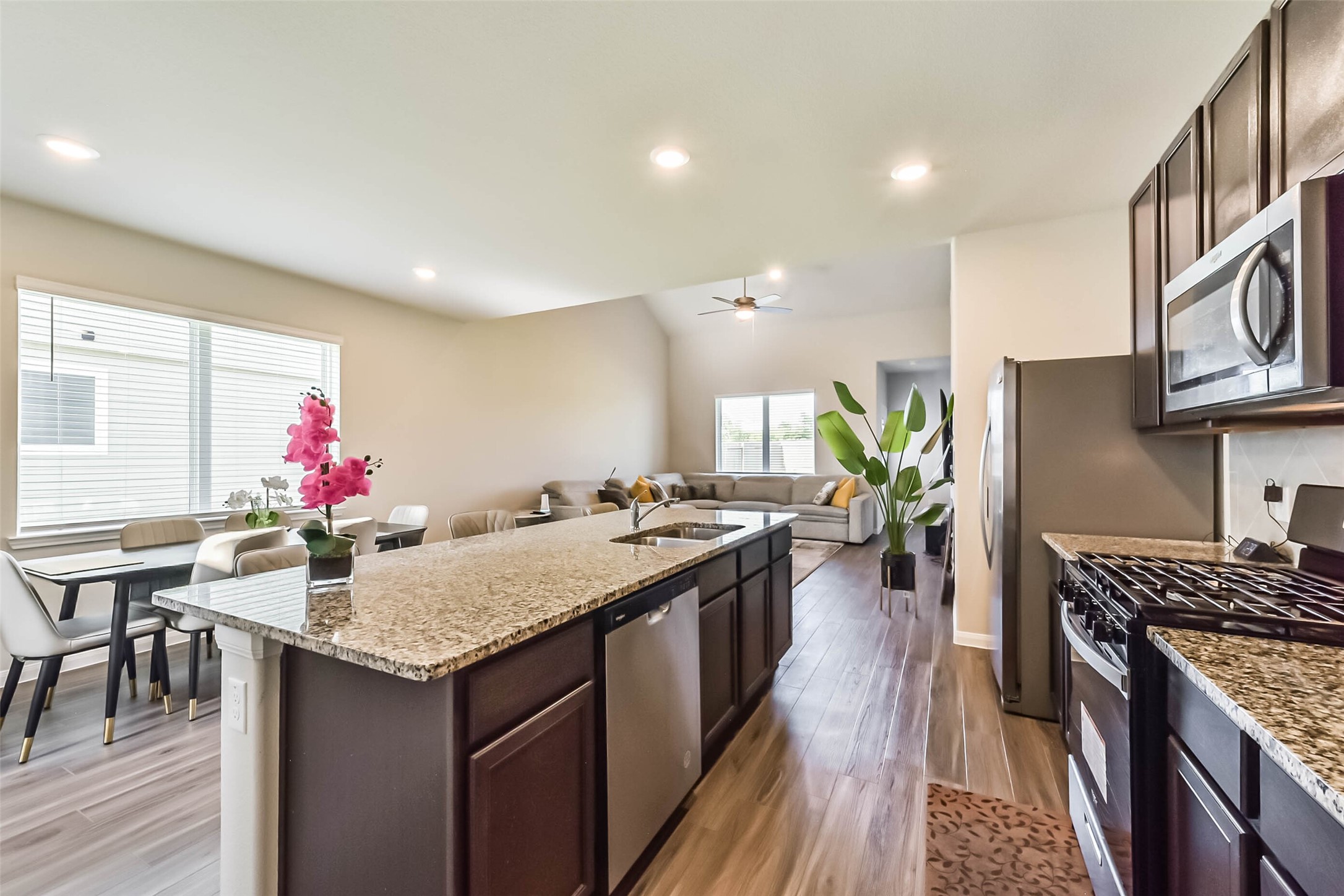 4907 Luke Matthew Drive Rosharon, TX 77583 - Photo 12 of 42 a kitchen with stove top oven table and chairs