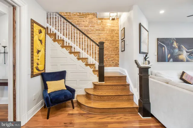 a view of entryway and hall with wooden floor