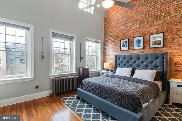 a bed sitting in a bedroom next to a window