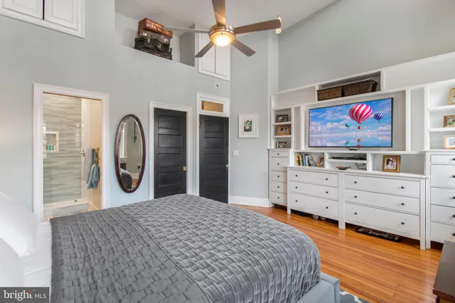 a bedroom with a bed and a chandelier