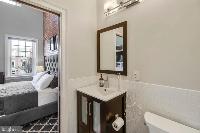 a bathroom with a toilet sink and mirror