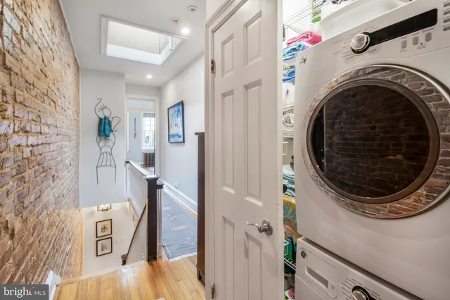 a view of a storage and utility room with a washer dryer