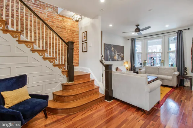 a living room with wooden floor and furniture