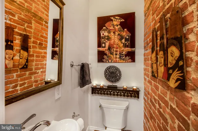 a bathroom with a toilet a sink and a shower curtain