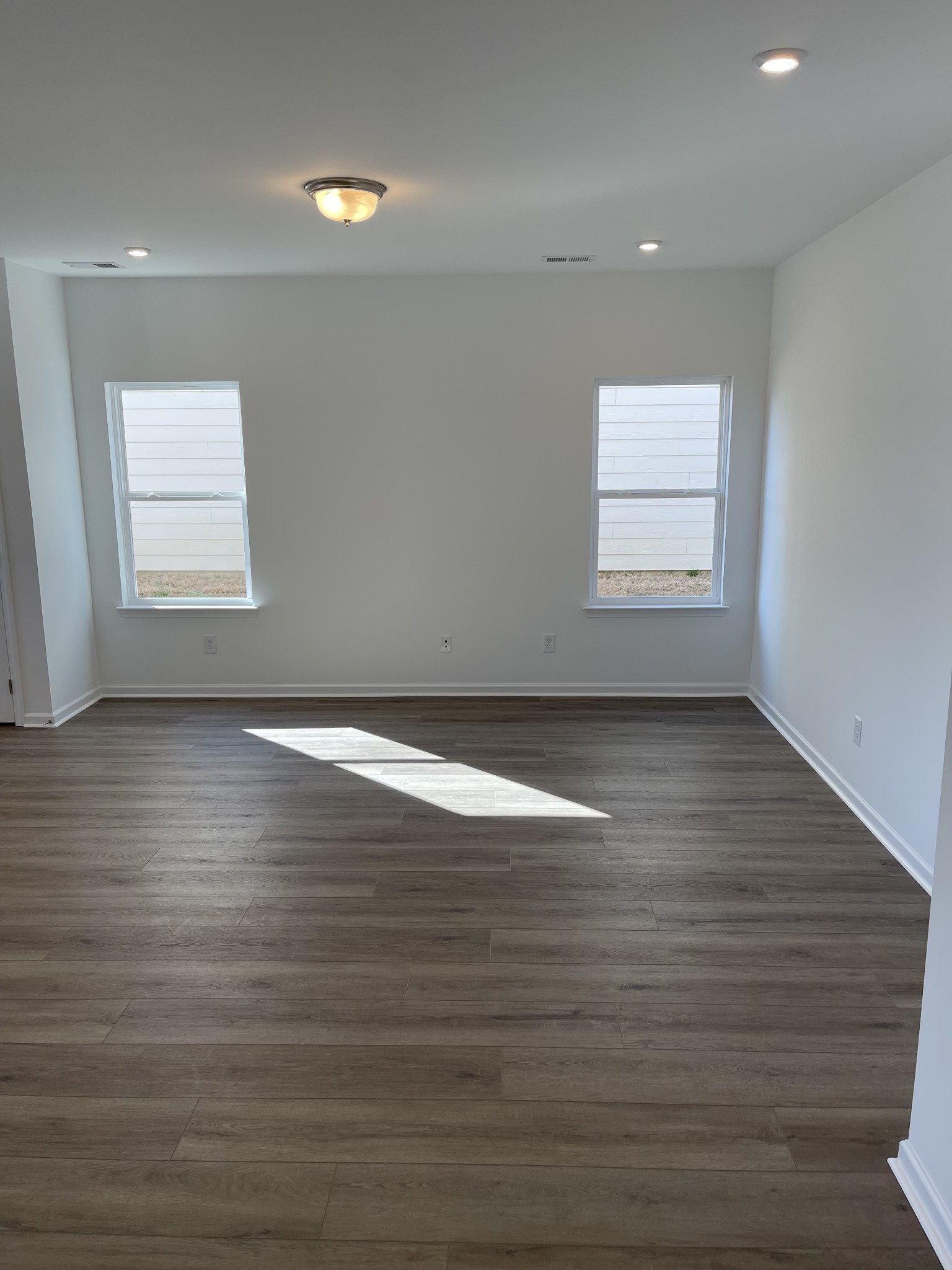 356 Winston Way Gallatin, TN 37066 - Photo 14 of 28 an empty room with wooden floor and windows