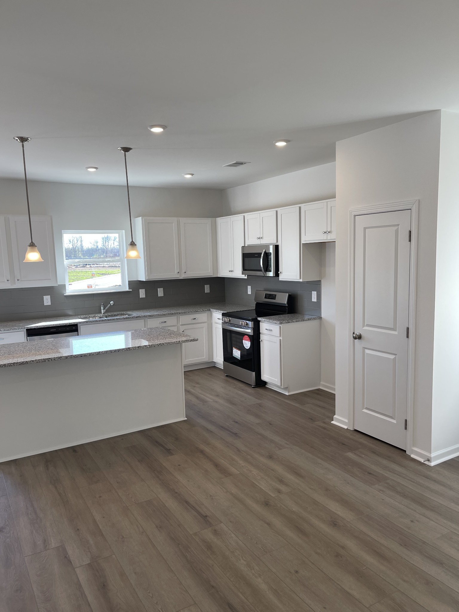 356 Winston Way Gallatin, TN 37066 - Photo 15 of 28 a large kitchen with stainless steel appliances granite countertop a stove a sink and a refrigerator
