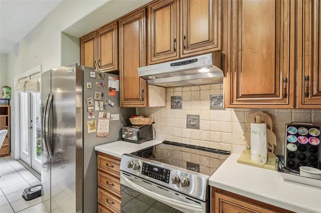 a kitchen with stainless steel appliances granite countertop a stove and a refrigerator