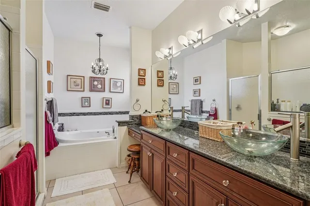 a bathroom with a granite countertop sink a large mirror and shower