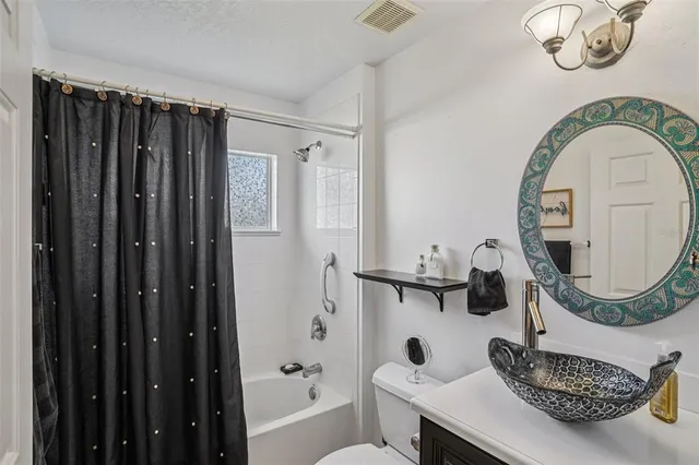 a bathroom with a sink a mirror and a toilet