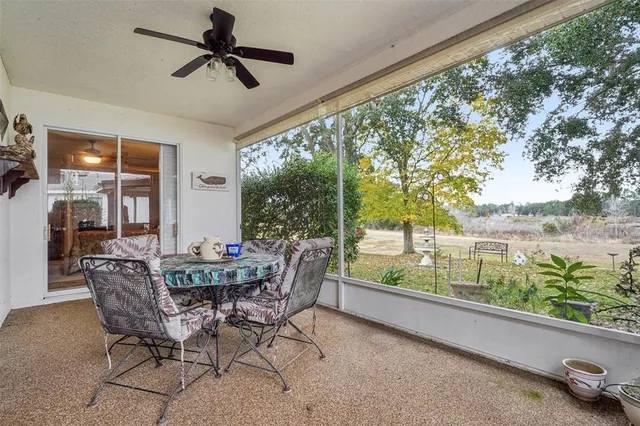 a dining room with furniture and garden view