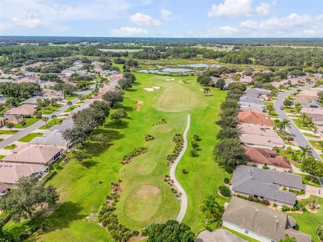 an aerial view of residential houses with outdoor space and swimming pool