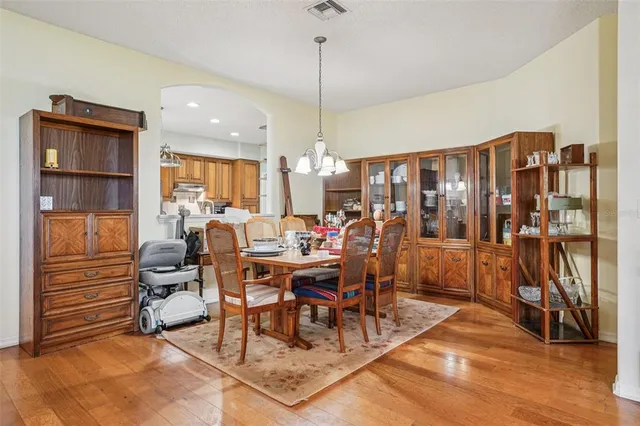 a view of a a dining room with furniture window and wooden floor