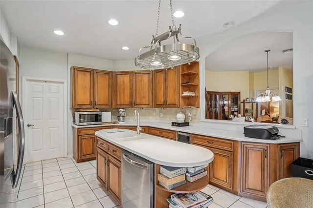a kitchen with stainless steel appliances granite countertop a sink and a refrigerator