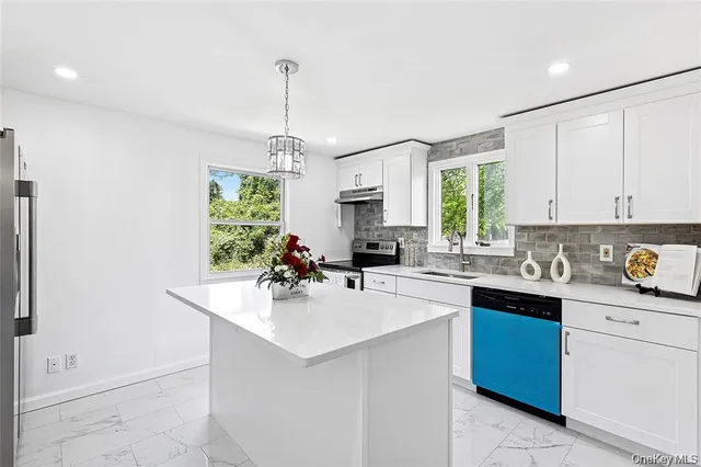 a kitchen with a sink window and cabinets