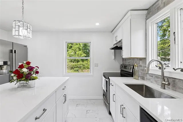 a kitchen with a sink cabinets and window