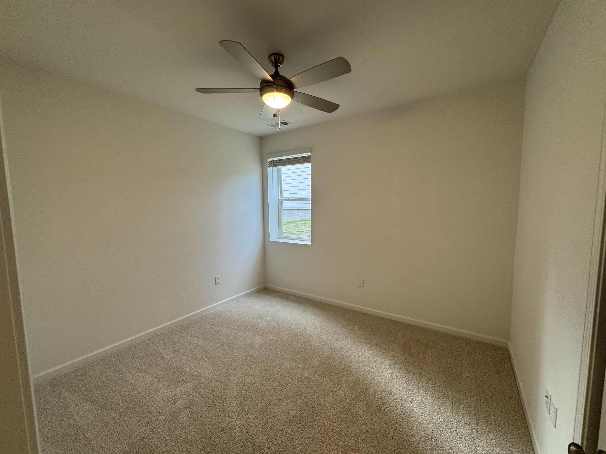 410 Blair Road Smyrna, TN 37167 - Photo 16 of 27 an empty room with a chandelier fan and windows