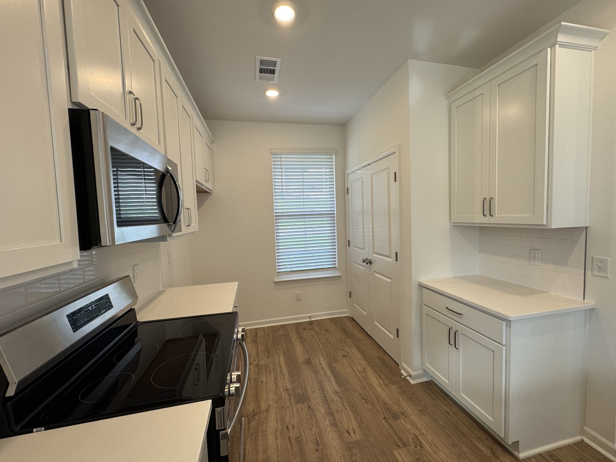 410 Blair Road Smyrna, TN 37167 - Photo 9 of 27 a kitchen with a sink wooden floor and stainless steel appliances