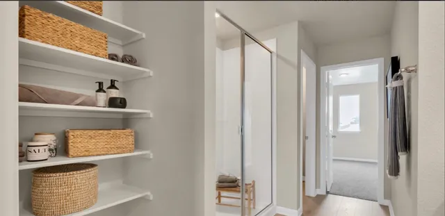 a bathroom with double vanity sink a mirror and a shower