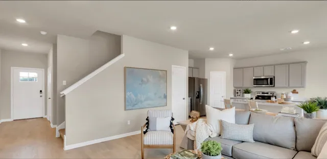 a living room with stainless steel appliances kitchen island furniture and a view of kitchen