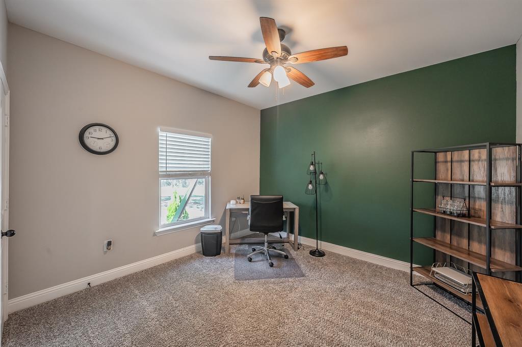 117 Rock Salt Drive Springtown, TX 76082 - Photo 23 of 38 Vaulted ceiling with a wood-finish ceiling fan, a window with blinds, and a built-in shelving unit with wood-finish shelves and a black metal frame