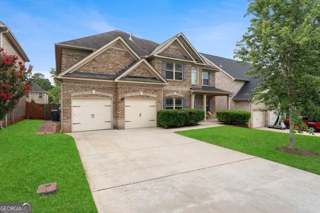 a front view of a house with garden