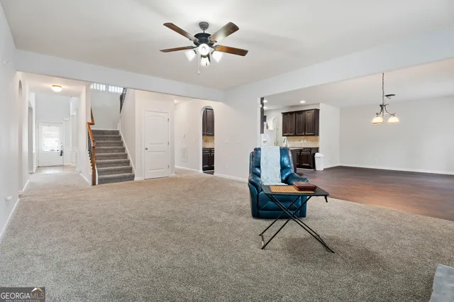 an empty room with a ceiling fan and a window
