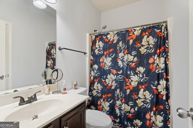 an empty room with a window and a ceiling fan