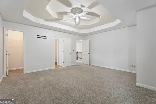 a view of a kitchen with granite countertop a sink and dishwasher a stove with wooden floor
