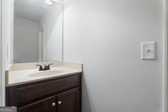 a bathroom with a sink vanity and a mirror