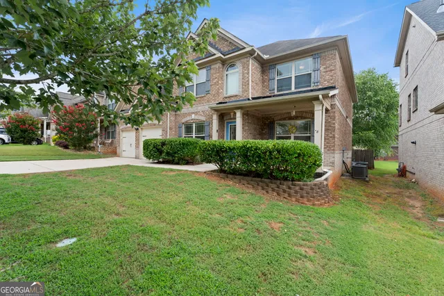 a front view of a house with a yard