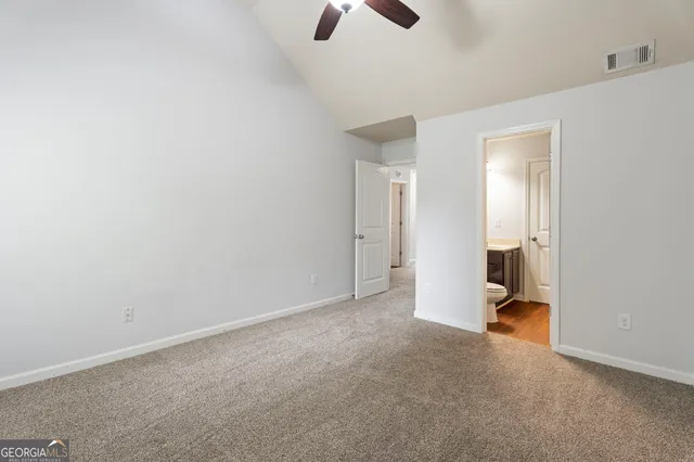 a view of a house with backyard and a tree