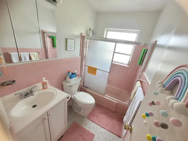 a bathroom with a sink and mirror with toilet