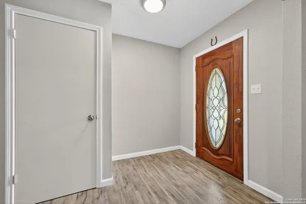 a view of front door with wooden floor