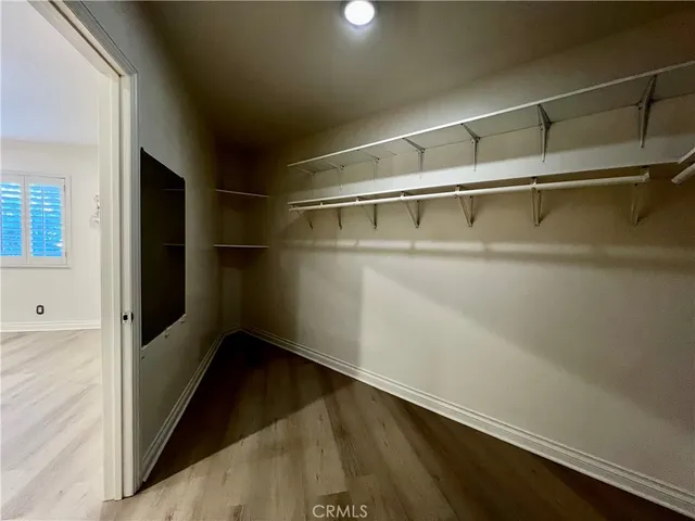 a view of storage and utility room with wooden floor