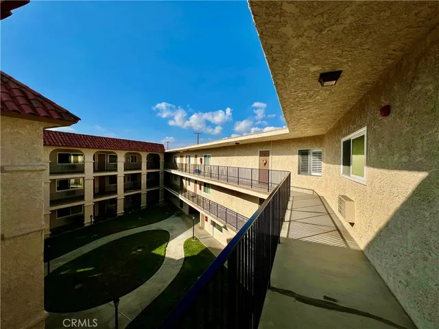 a view of a house with pool and wooden fence