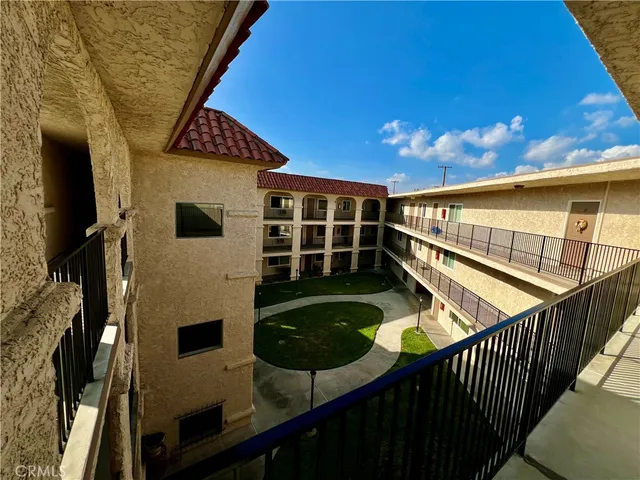 a view of balcony with wooden floor and fence
