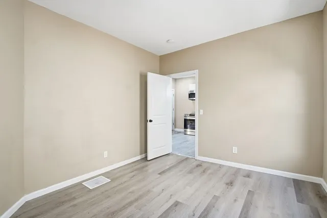 an empty room with wooden floor