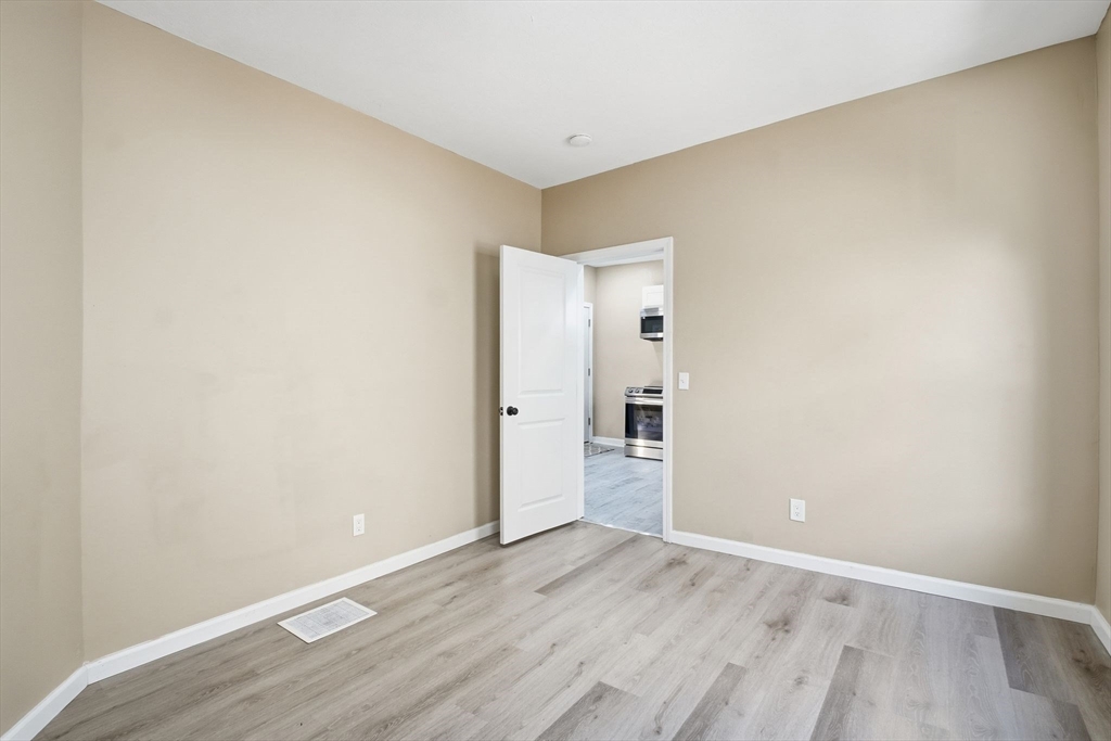 52 Osgood Street Springfield, MA 01107 - Photo 11 of 42 an empty room with wooden floor