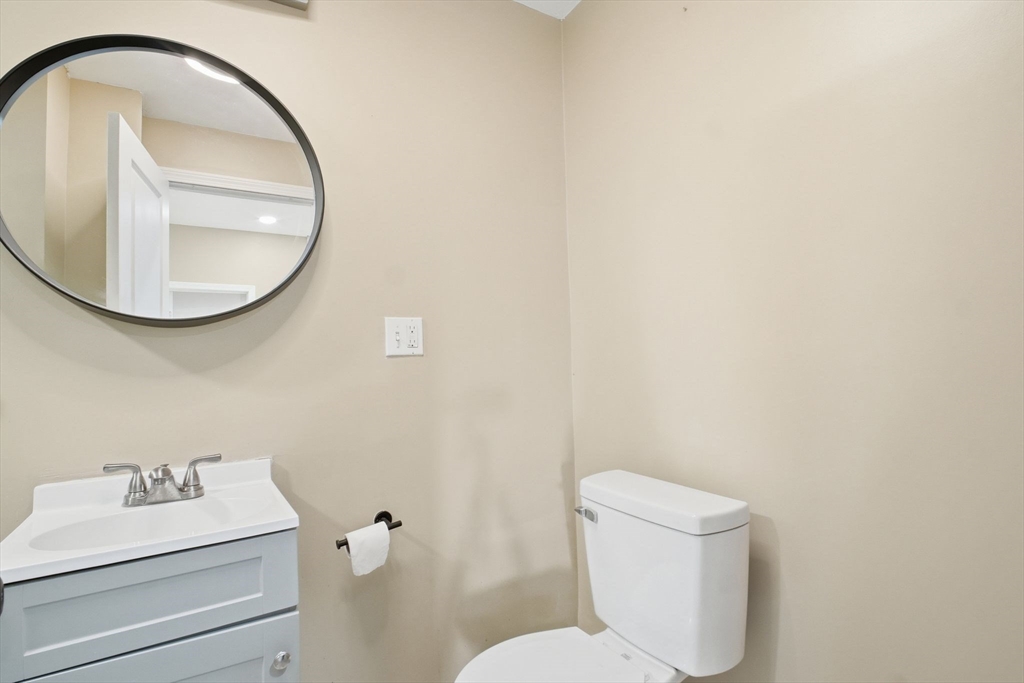 52 Osgood Street Springfield, MA 01107 - Photo 12 of 42 a bathroom with a toilet sink and mirror
